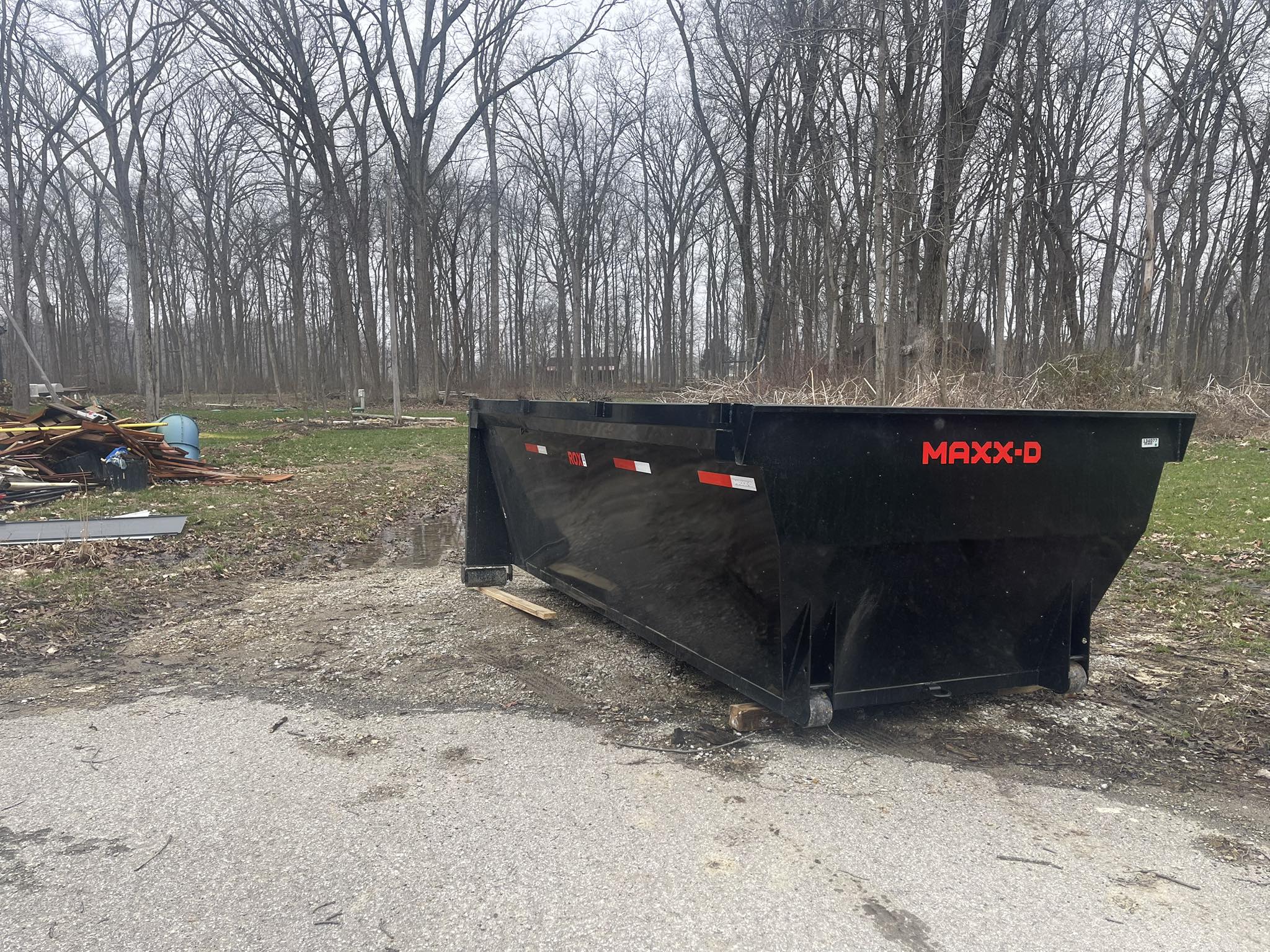 Redline Hauling roll-off dumpster on Knox County build site