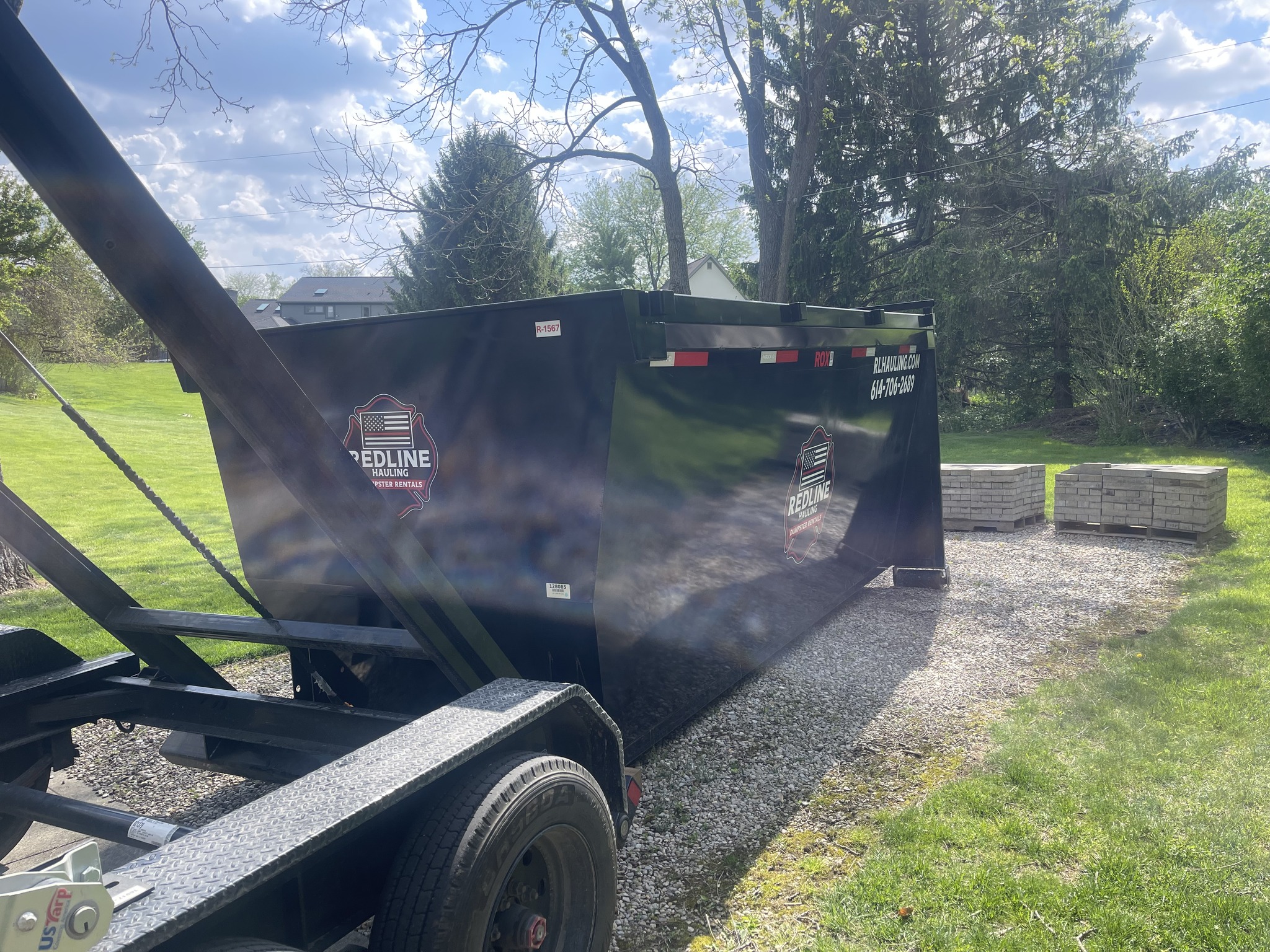Redline Hauling firefighter-owned dumpster rental in Westerville OH — roll-off truck on delivery