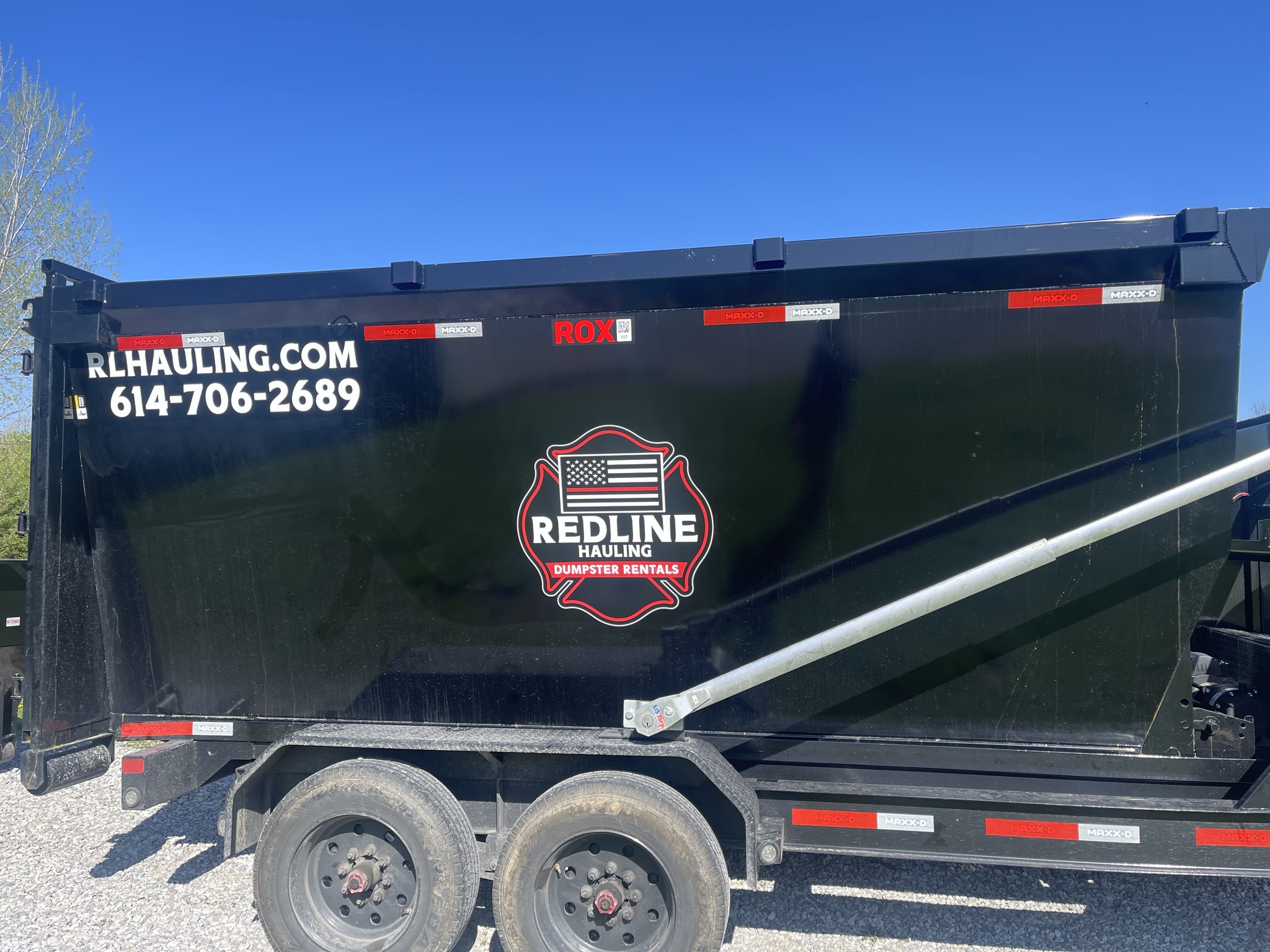 Redline Hauling red Peterbilt truck and roll-off dumpster ready for delivery in Westerville Ohio